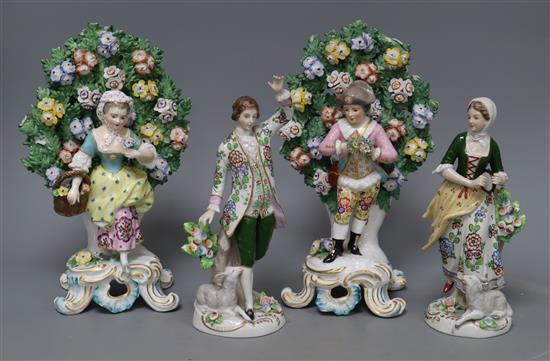 A Sitzendorf pair of shepherd and shepherdess figures holding flowers and a pair of Samson Chelsea style bocage figures